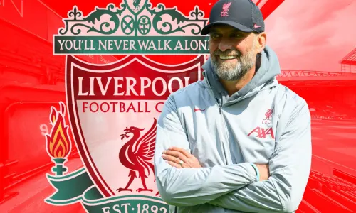 Jurgen Klopp and the Liverpool badge, in front of a panorama of Anfield in red